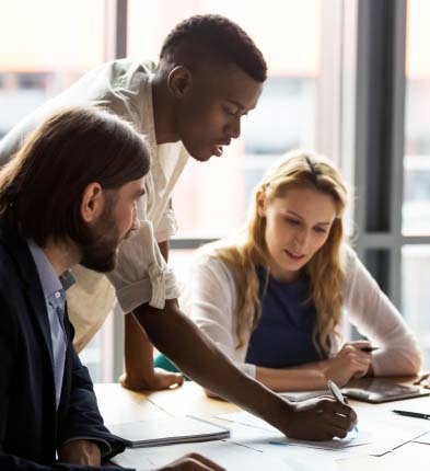 Three business people having discussion around table
